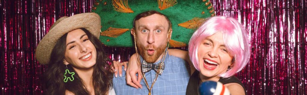 people posing infront of a vintage photo booth