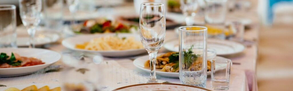 dinner tables set with plates and glasses at a luxury wedding reception in bradford