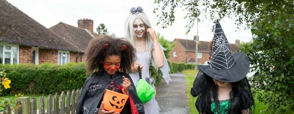 kids in halloween outfits walking to a halloween festival