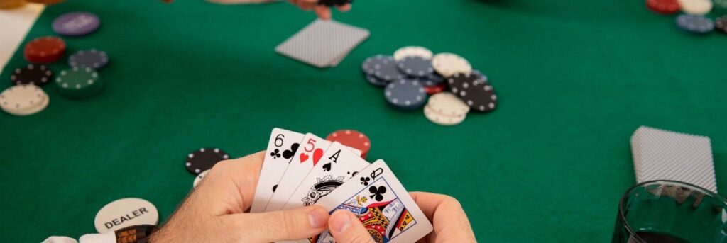 casino dealer dealing out cards and a craps table