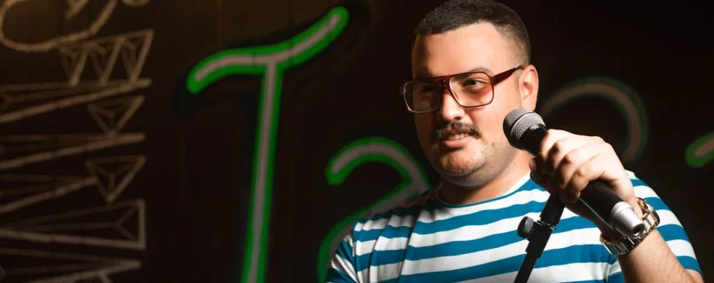 a standup comedian holding a microphone doing wedding standup comedy