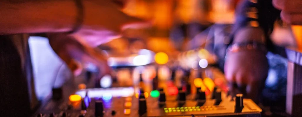 abstract view of a dj's cd decks at a wedding with someone making a personalised request