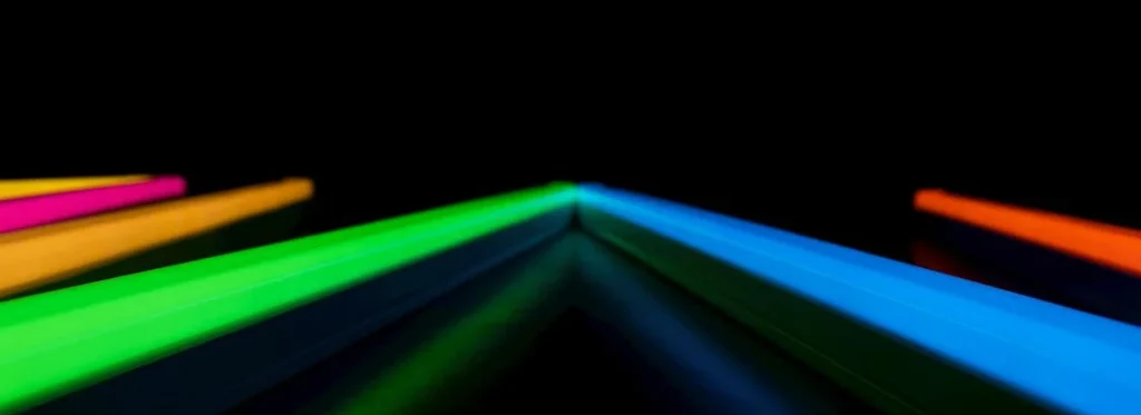 abstract view of blue, green, organge, and red glow sticks at a wedding