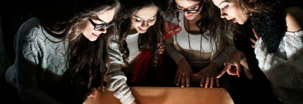 wedding guests looking inside a mobile escape room