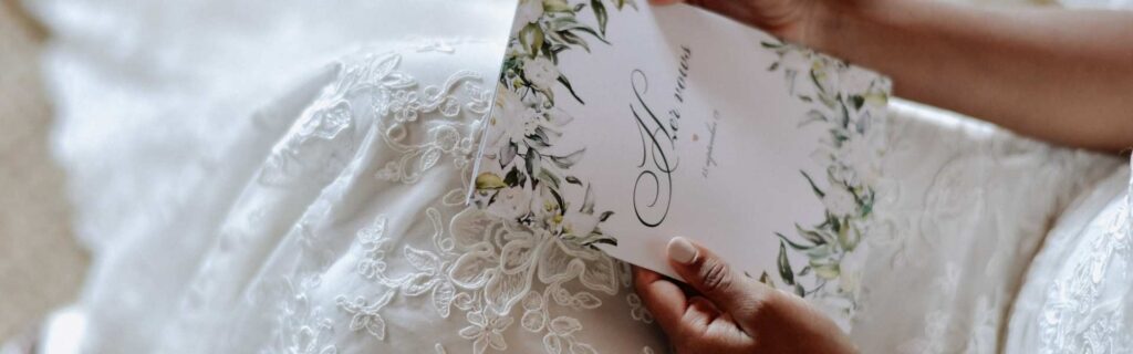 bride writing personalised wedding vow on a card