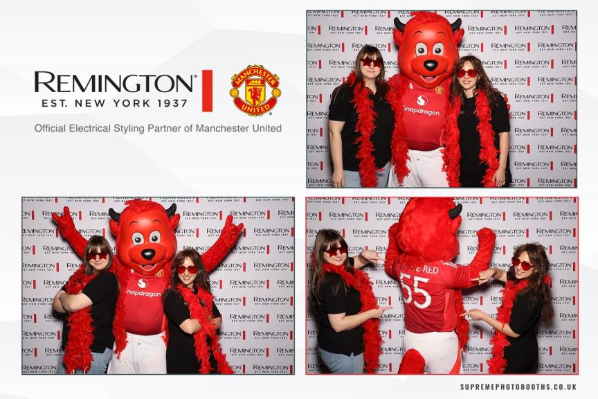 manchester united mascot with 2 woman taking a picture on a magic mirror at old trafford football ground