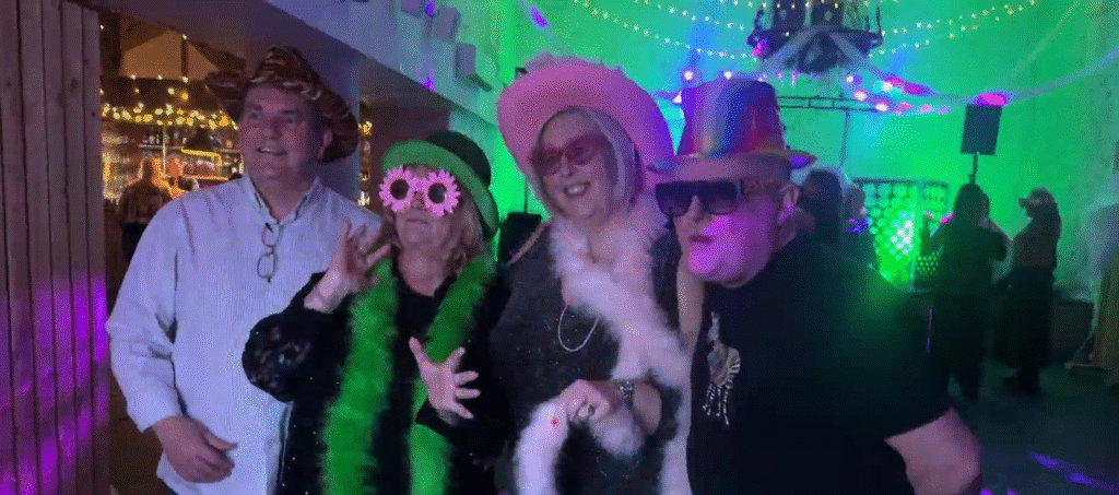 guests taking a picture on the photo booth at The Barn at Faenol Fawr