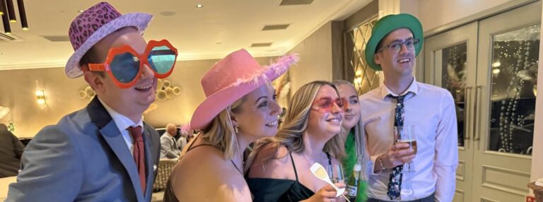 guests at grosvenor pulford using props for a photo booth