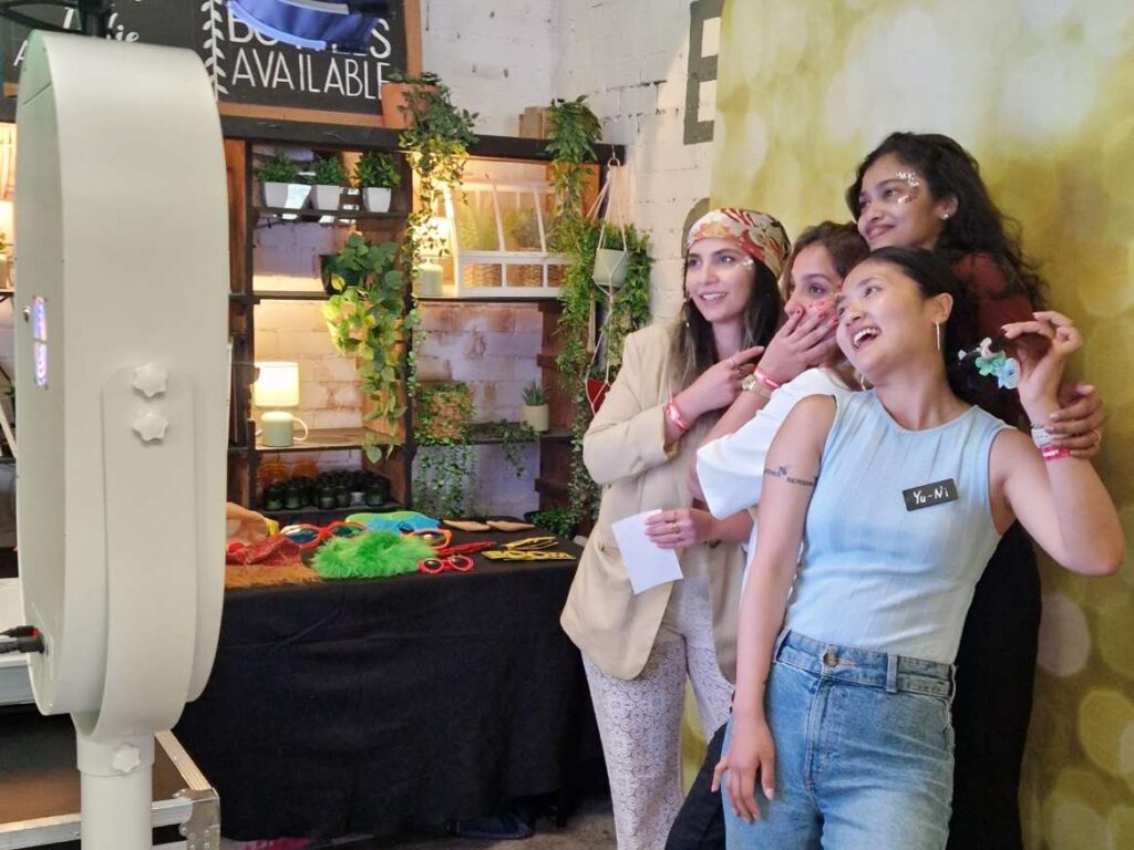 people taking a picture on a photo booth in manchester