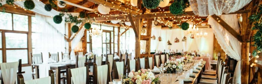 inside a rustic barn wedding venue with tables set for reception