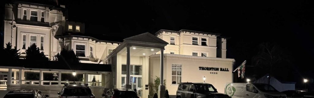front of thornton hall hotel building at night