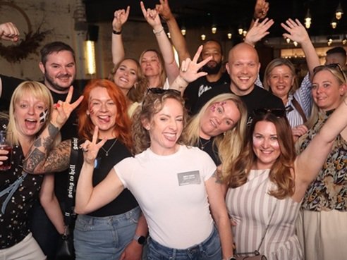 employees at a work party making a boomerang video on a photo booth