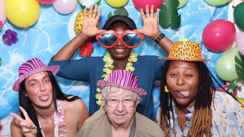 Be Caring Sheffield staff taking a photo booth picture at Hackenthorpe Community Centre in Sheffield