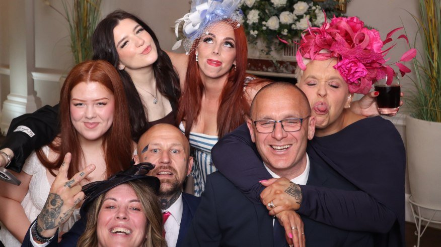 a group of wedding guests taking a picture