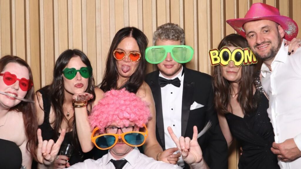 black-tie wedding with guests taking picture with props