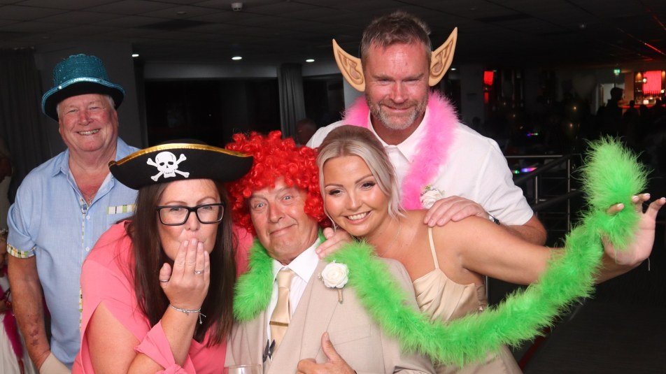 guests takng a picture with props at a wedding at Sheffield Utd Football Ground on Bramall Lane in Sheffield